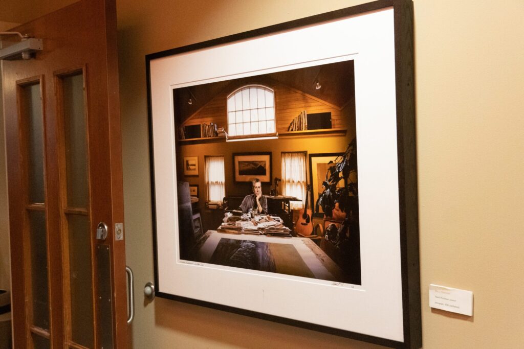 a framed photograph of a man sitting at a table