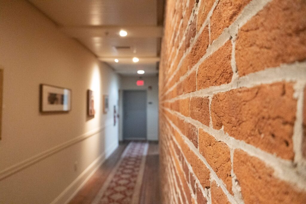 a brick wall in an office hallway