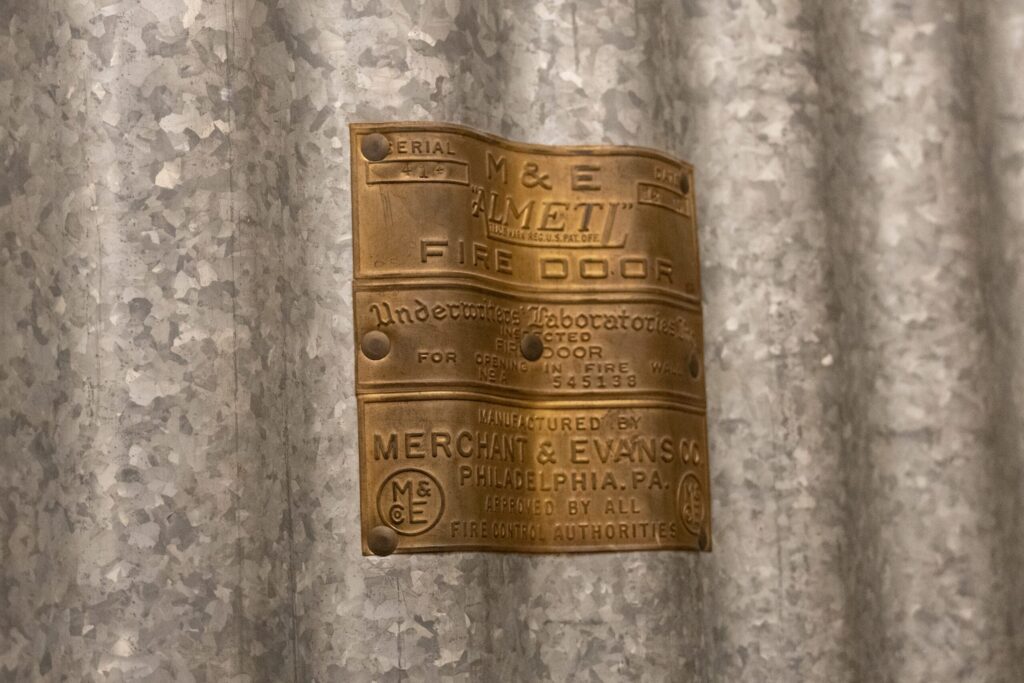 a close up of a metal curtain with a sign on it