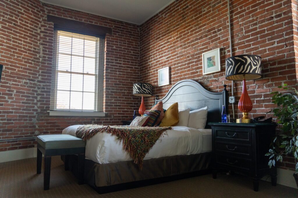 a bedroom with brick walls and a bed