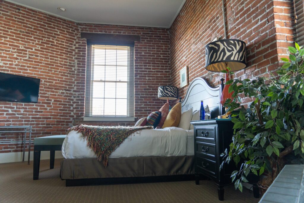 a bedroom with brick walls and a bed