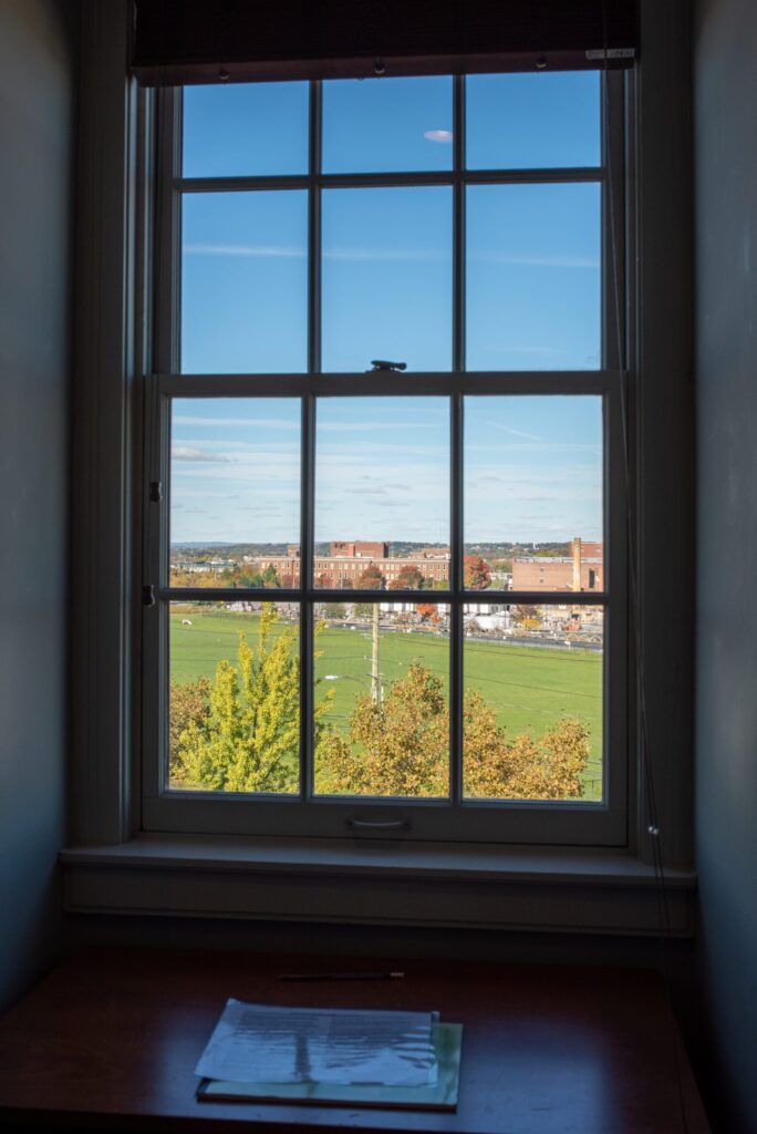a window with a view of a grassy field