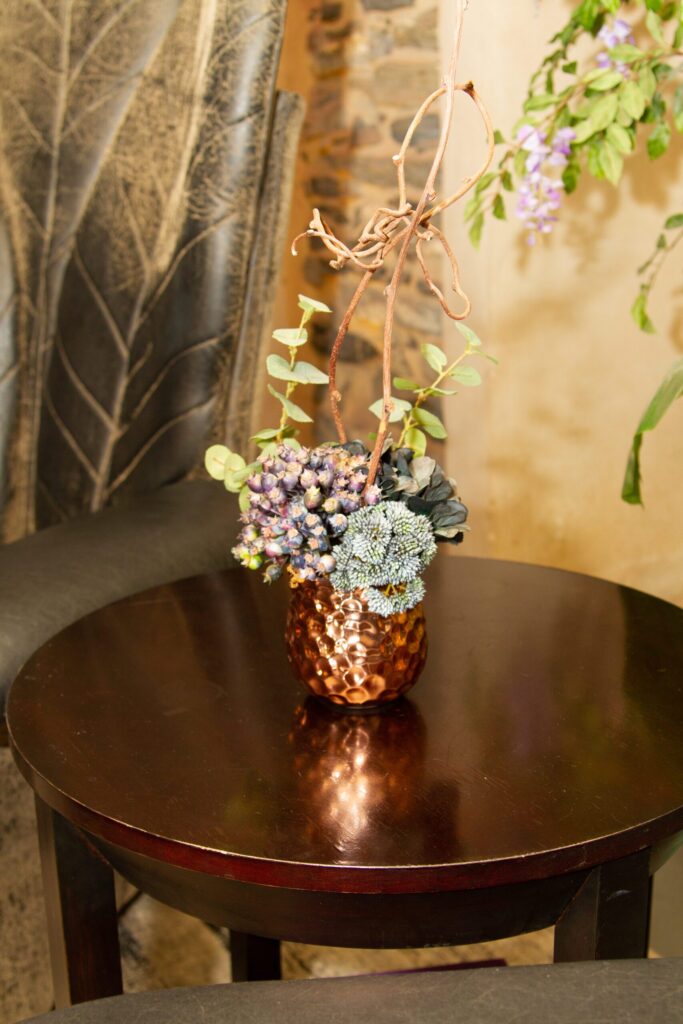 a vase with flowers on a table in a room