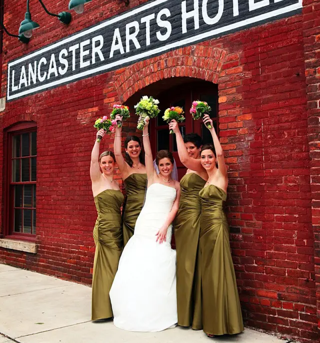 four bridesmaids pose in front of the lancaster arts hotel