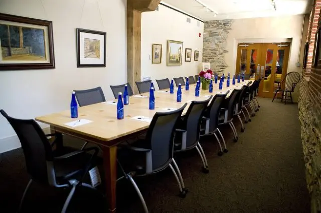 a long table with blue vases on top of it