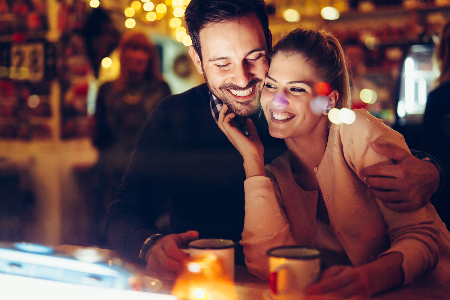 a happy couple, sitting closely together and smiling